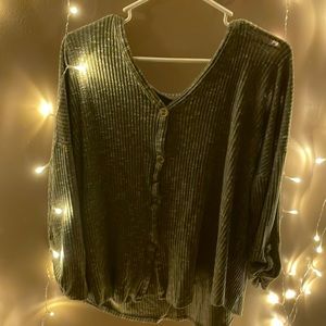 A green button sweater.